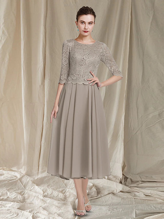 Detailed view of the jewel neckline and half sleeves of the elegant two-piece dress.
