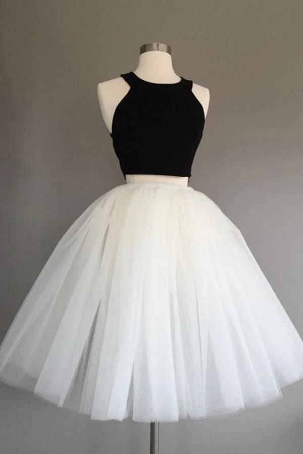 Model wearing a two-piece halter tulle knee-length homecoming dress.