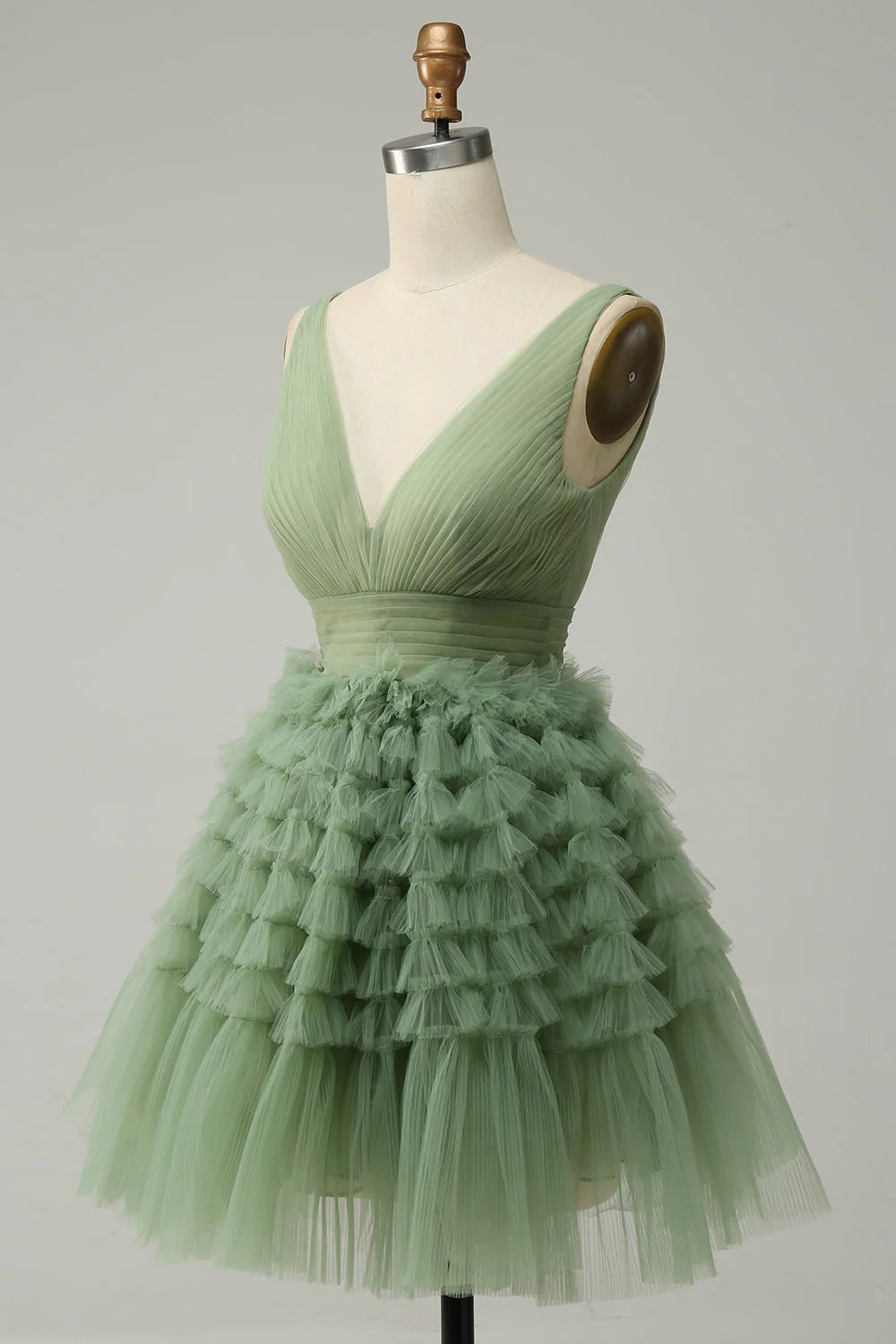 Side view of a short green tulle prom dress.