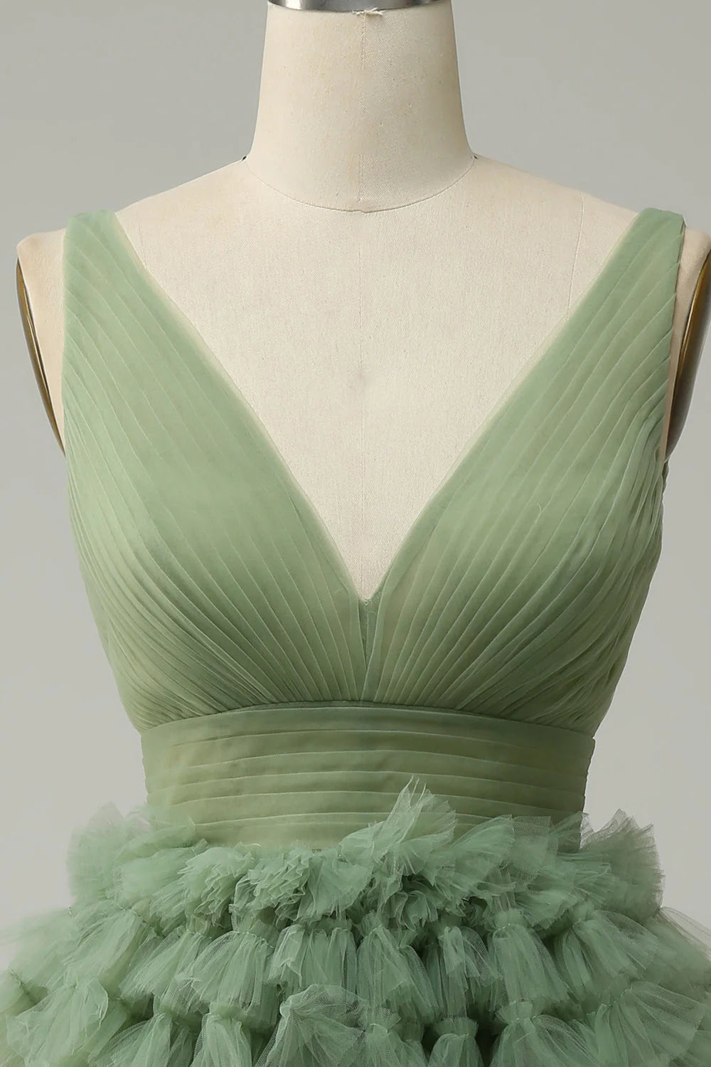 Close-up of the green tulle fabric on a short prom dress.