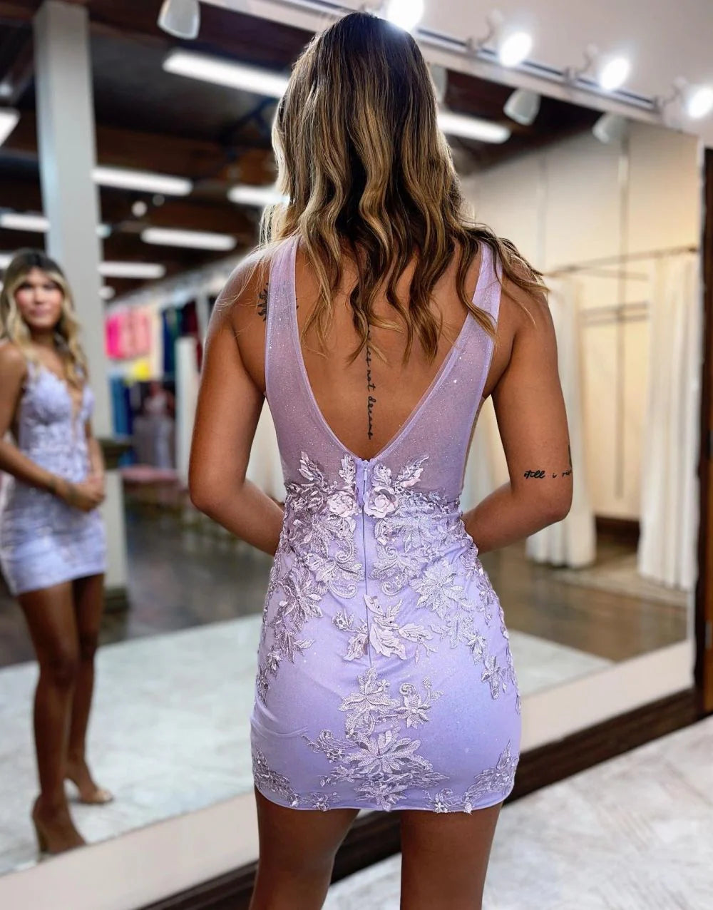 Back view of the V-neck short dress, showcasing sequin embellishments.