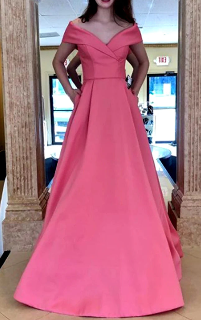 A woman wearing a classic off-shoulder A-line long prom dress in a solid color.