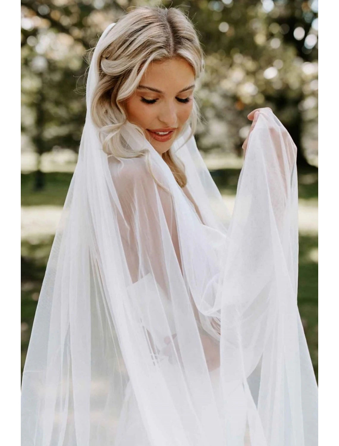 Bride wearing a classic one-tier chapel wedding veil.