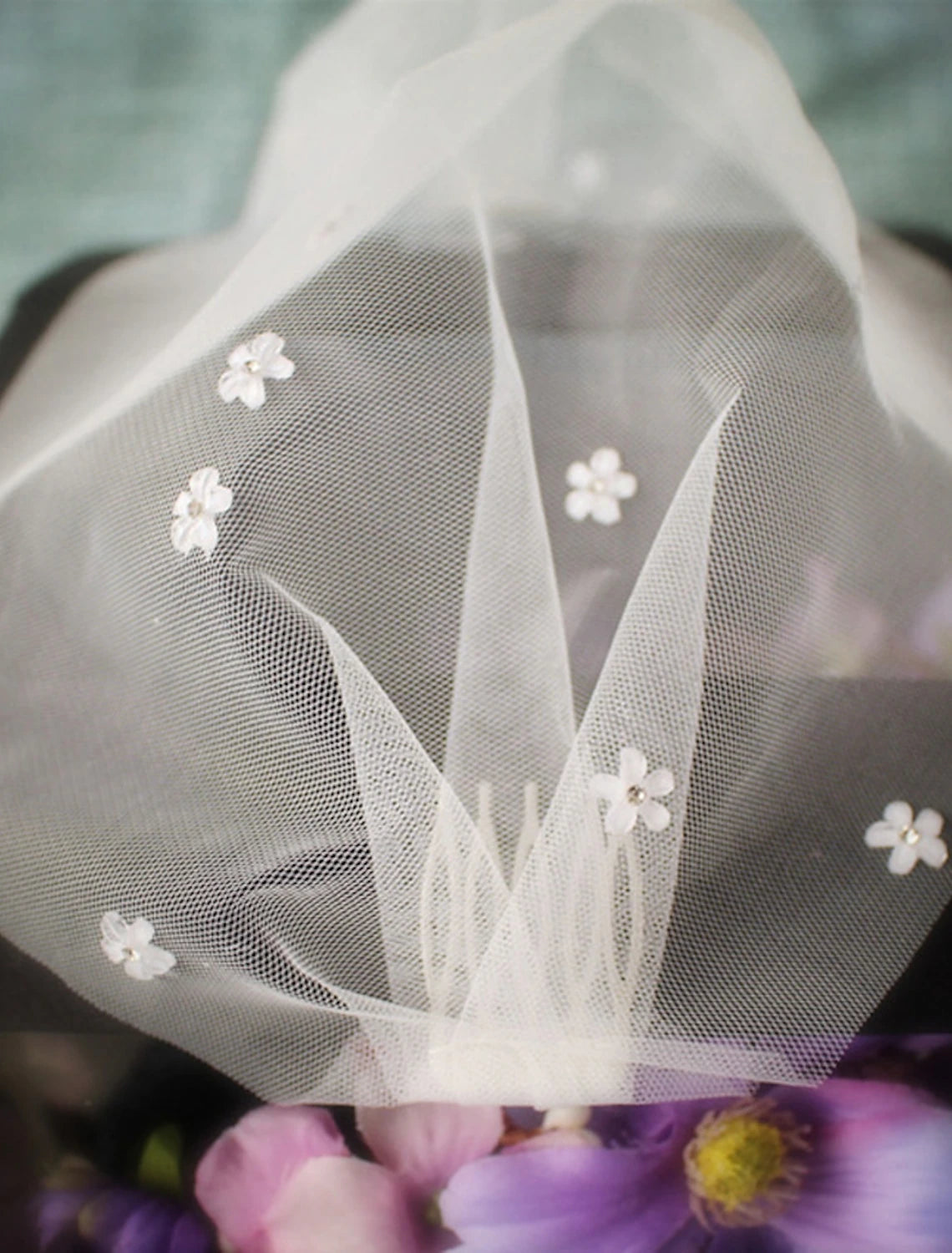 Side view of a bride wearing an elegant one-tier wedding blusher veil with crystal and rhinestone embellishments.