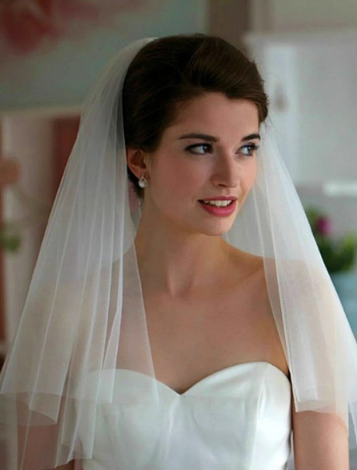 Front view of a bride with a 70cm shoulder length wedding veil.