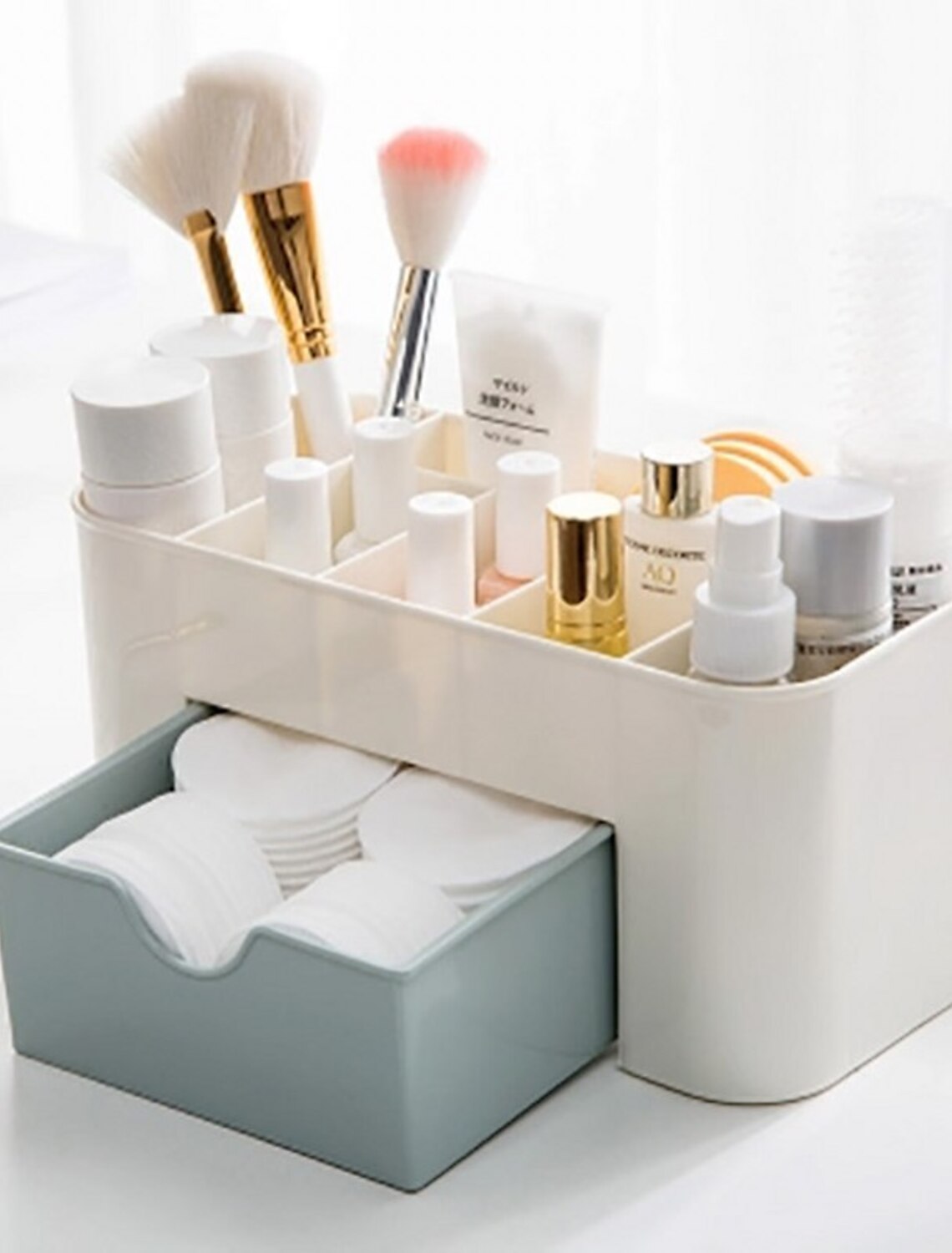 Clear plastic makeup organizer with multiple drawers.