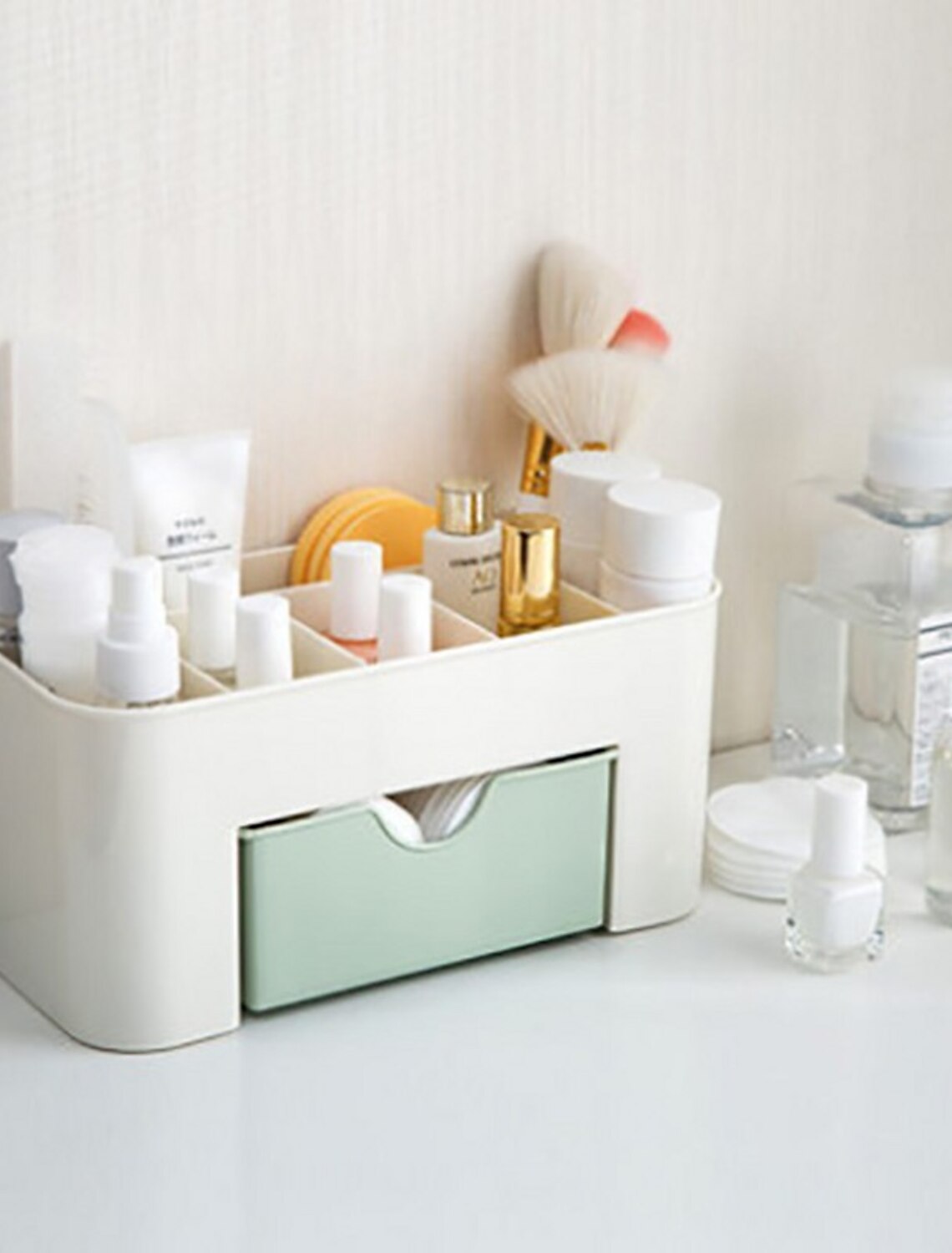 Desktop cosmetic storage box with drawers open, showing organized items.