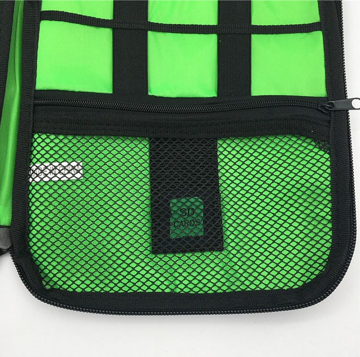 A blue portable cable organizer bag, open, displaying multiple compartments for cables and accessories.