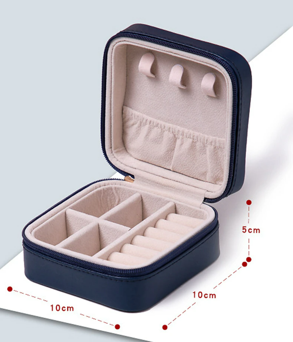 Open pink travel jewelry case showing multiple compartments.