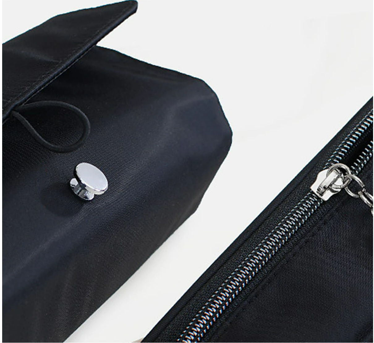 Black travel makeup brush case, rolled up and secured.