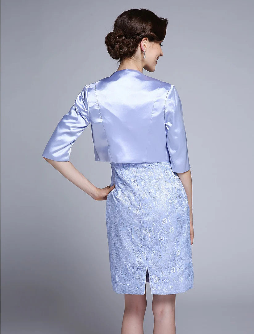 Woman posing elegantly in the formal satin lace Mother of the Bride gown.