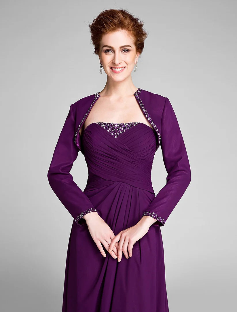 Woman wearing a strapless, floor-length convertible sheath dress with side draping and crystal details.
