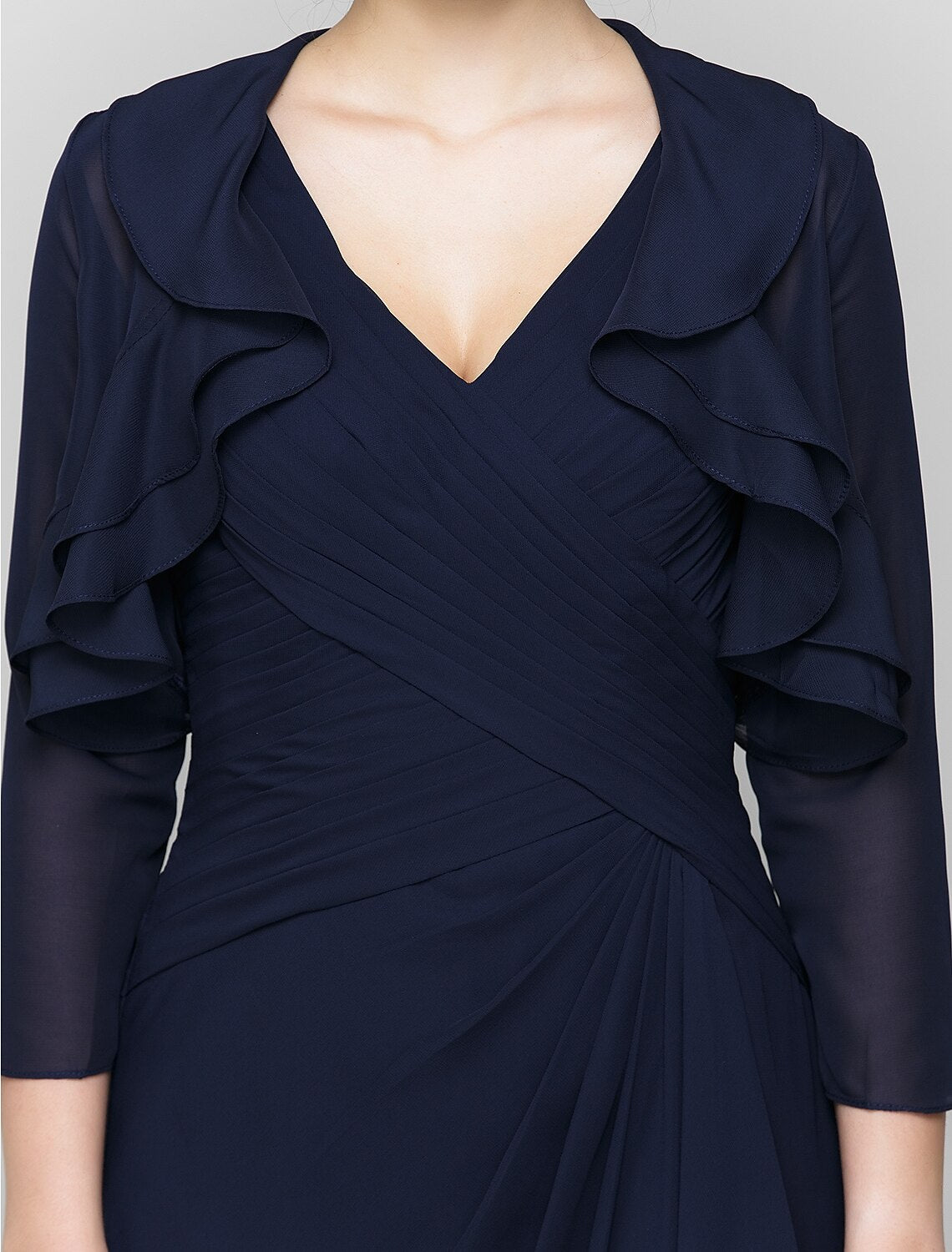Detail of the V-neckline and criss-cross ruffles on the formal dress.