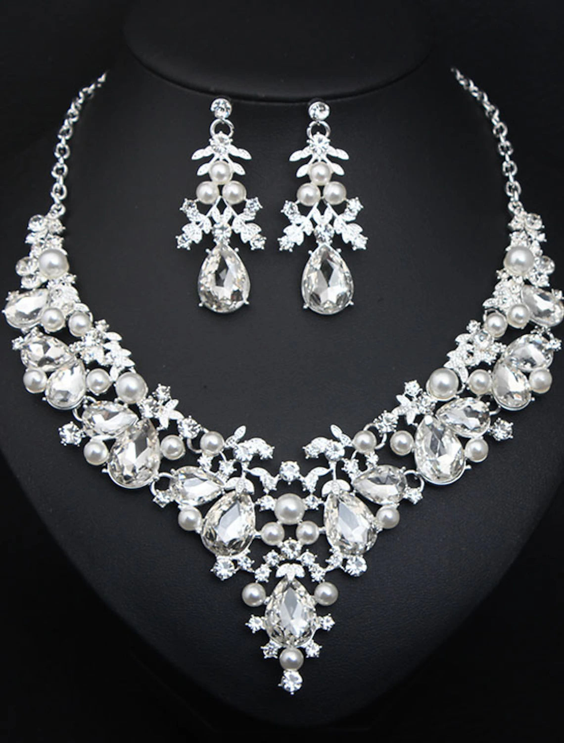 Detailed view of the rhinestone flower design on the bridal jewelry set.