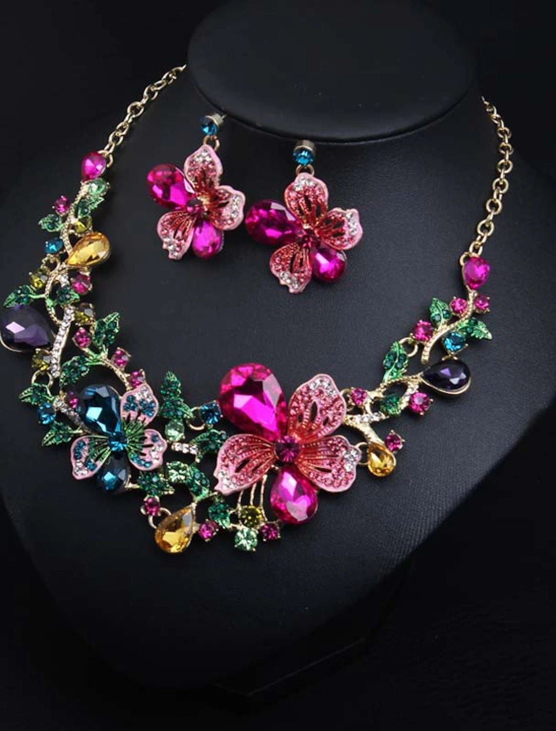 Bridal jewelry set with flower design on a display.