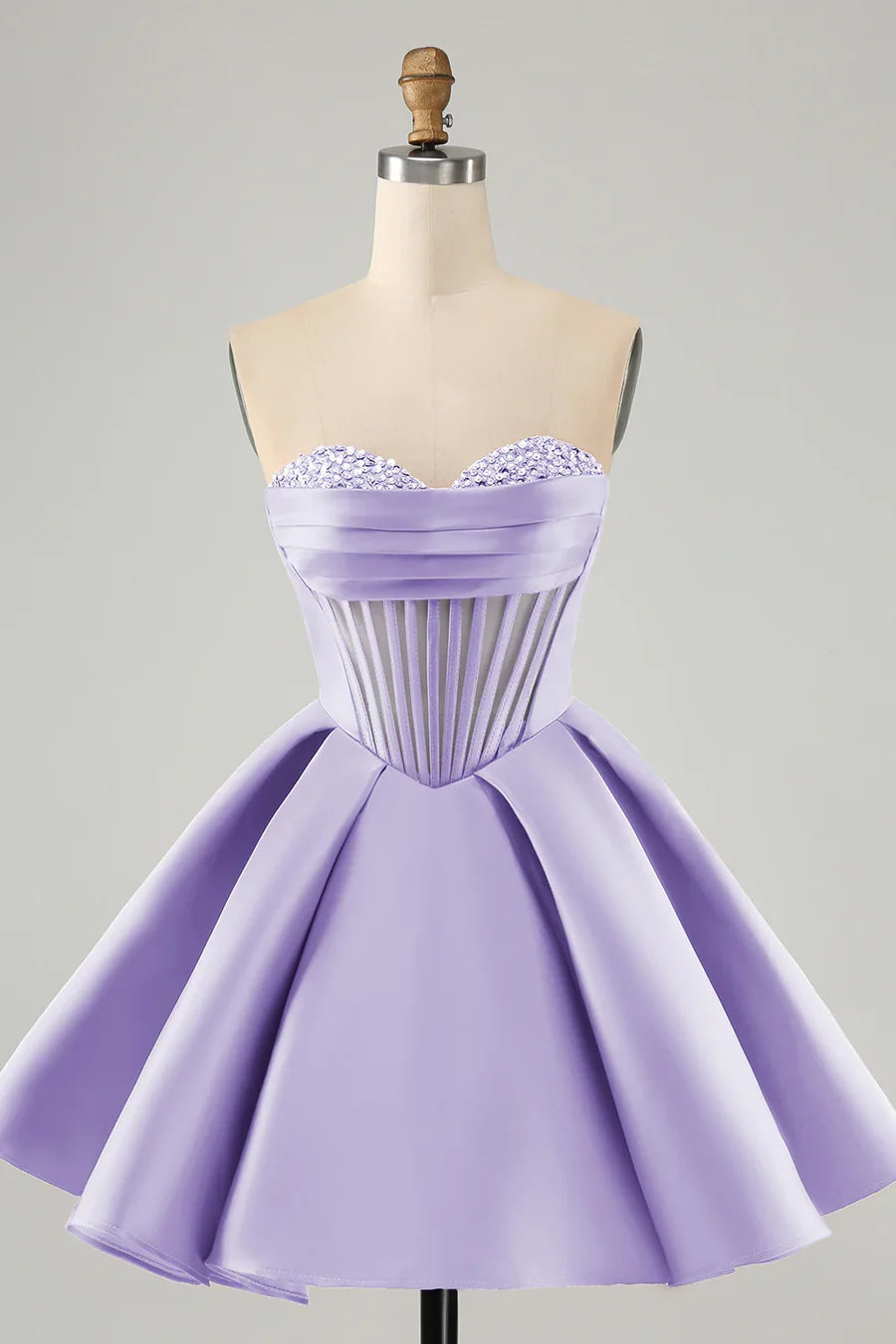 Back view of a model wearing a short A-line sweetheart corset homecoming dress, highlighting the corset and beading.
