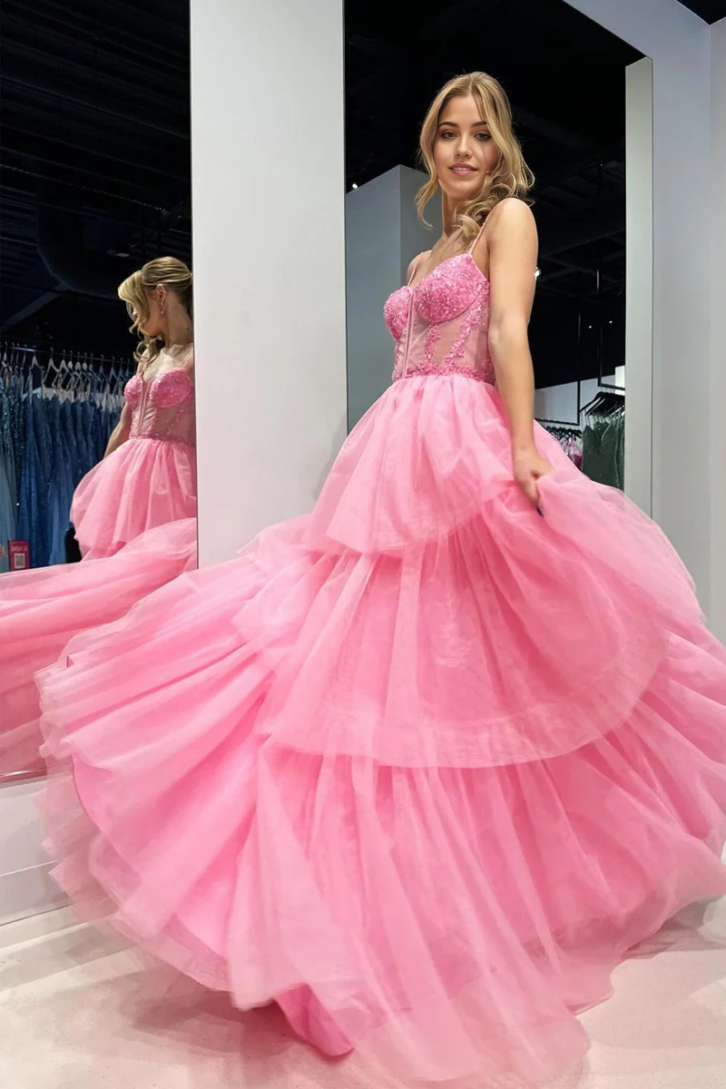Close-up of the tiered tulle skirt and pink fabric of the evening dress.