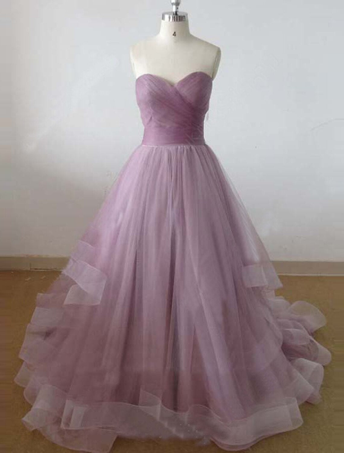 Side view of A-Line dress showing court train and ruffles.