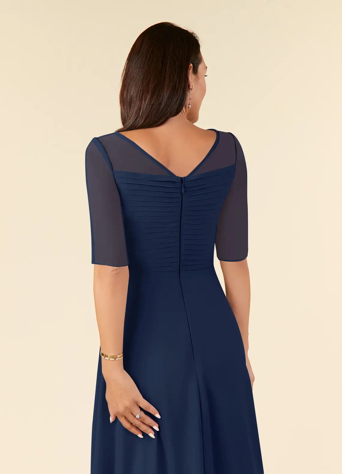 Close-up of the pleated chiffon fabric on a dark navy dress.