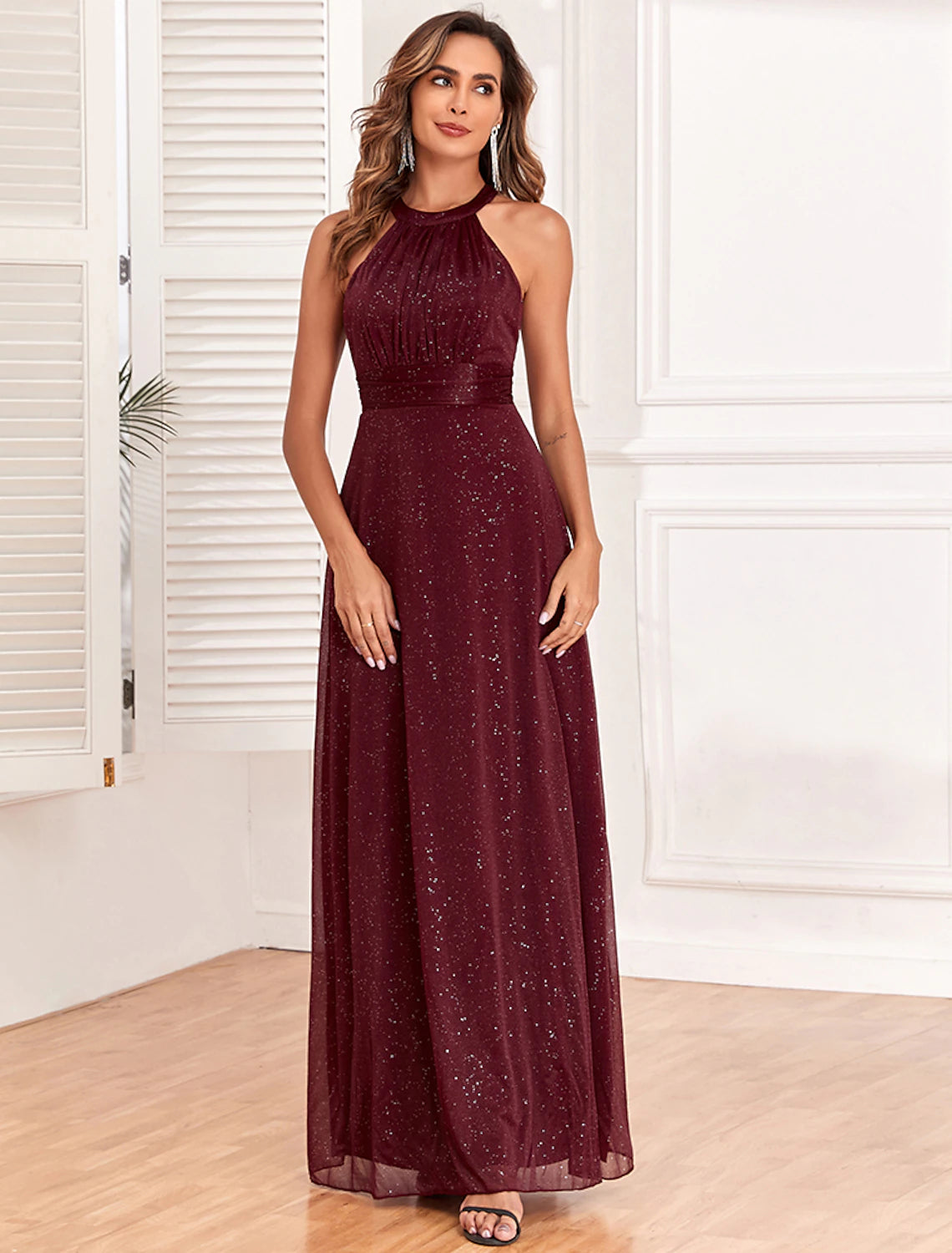 Close-up of the glitter fabric and halter neckline of the dress.