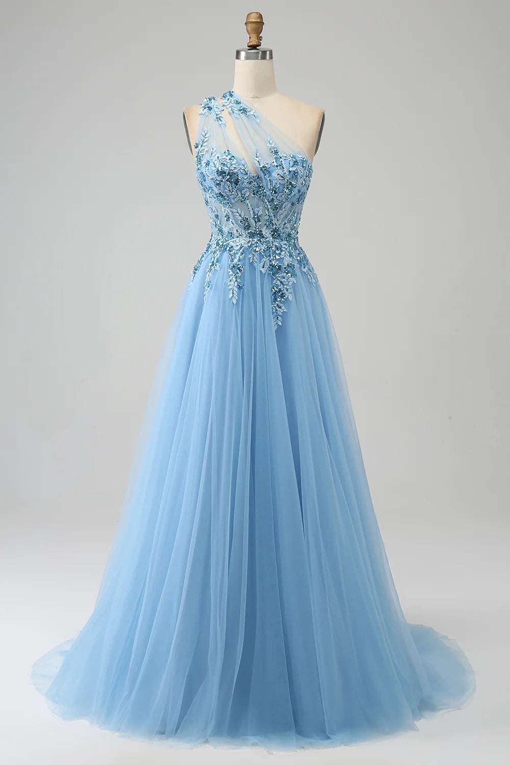 Model wearing a light yellow A-line one-shoulder sequin prom dress with appliques.