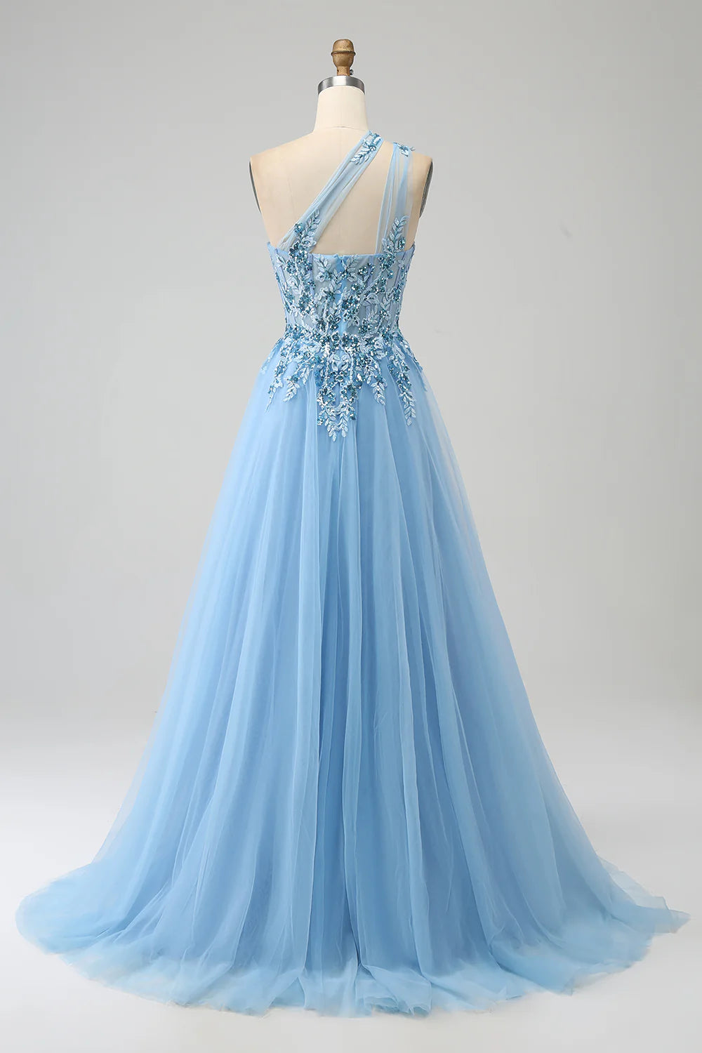Close-up of the sequin and applique details on the light yellow prom dress.