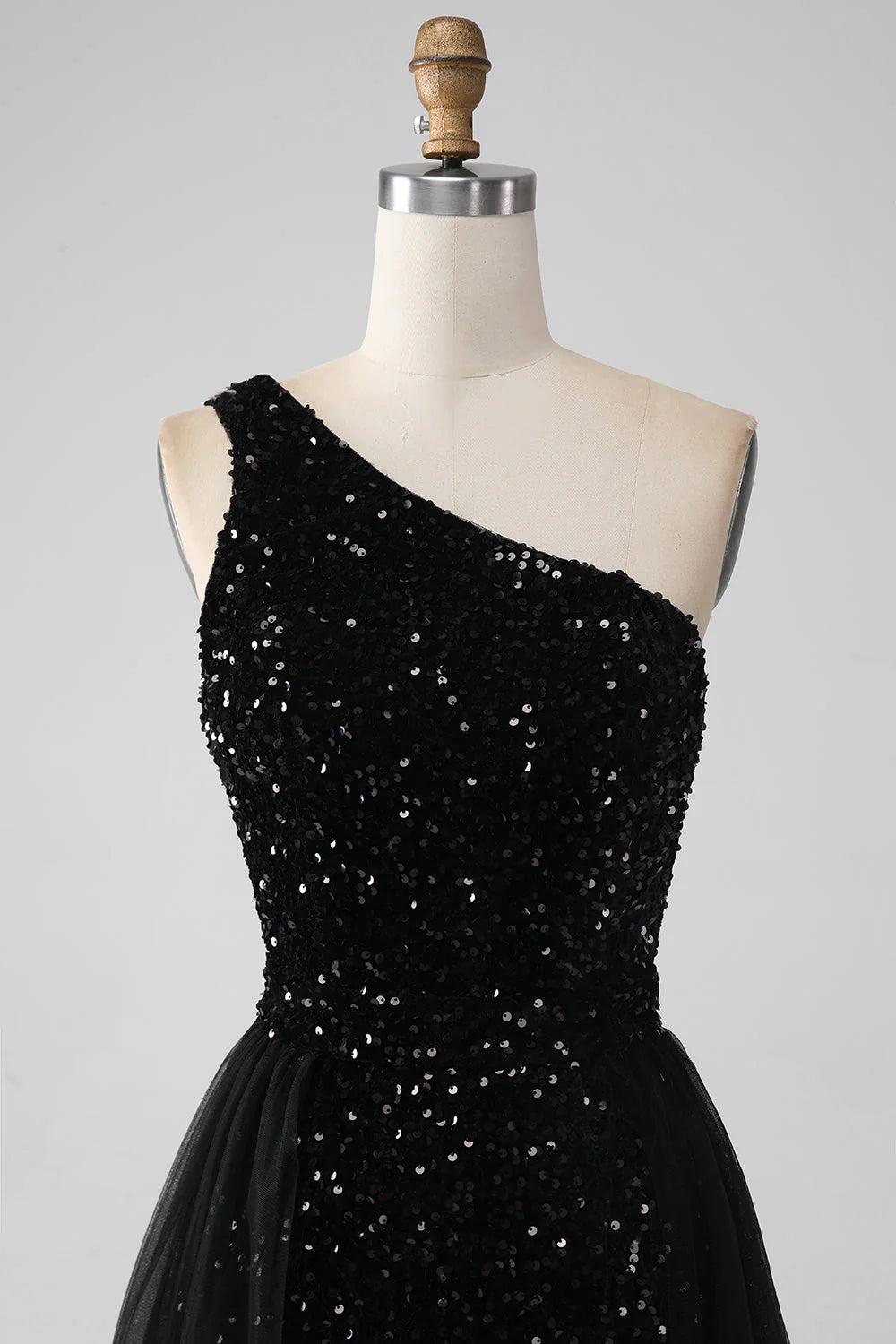 Back view of a black A-line one-shoulder sequin prom dress.