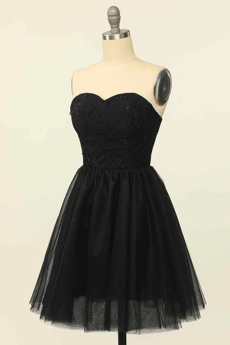 Close-up of the intricate lace and beaded details on the strapless dress.