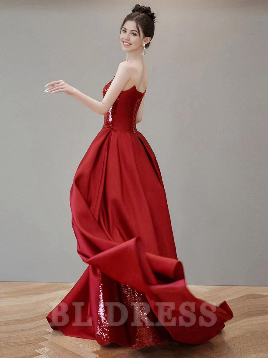 Side view of a dazzling sequined A-line gown, showcasing its court train.