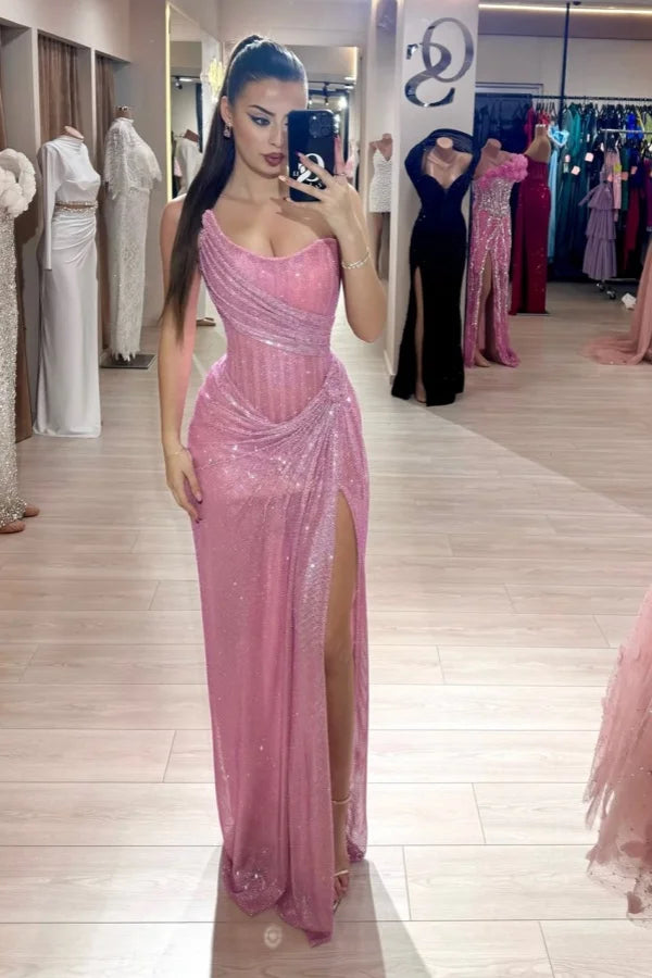 Woman wearing a dazzling sequined strapless A-line prom dress with a high leg split.