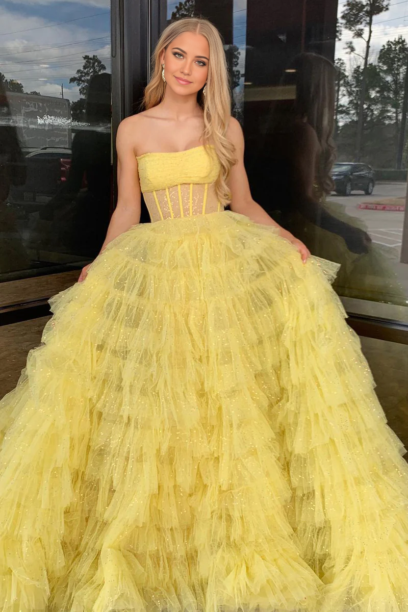Yellow A-line strapless prom dress with sequin bodice and tulle skirt.