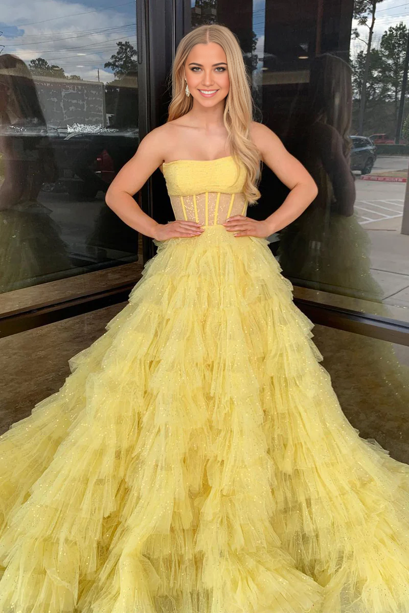 Close-up of sequin detail on yellow strapless A-line prom dress.