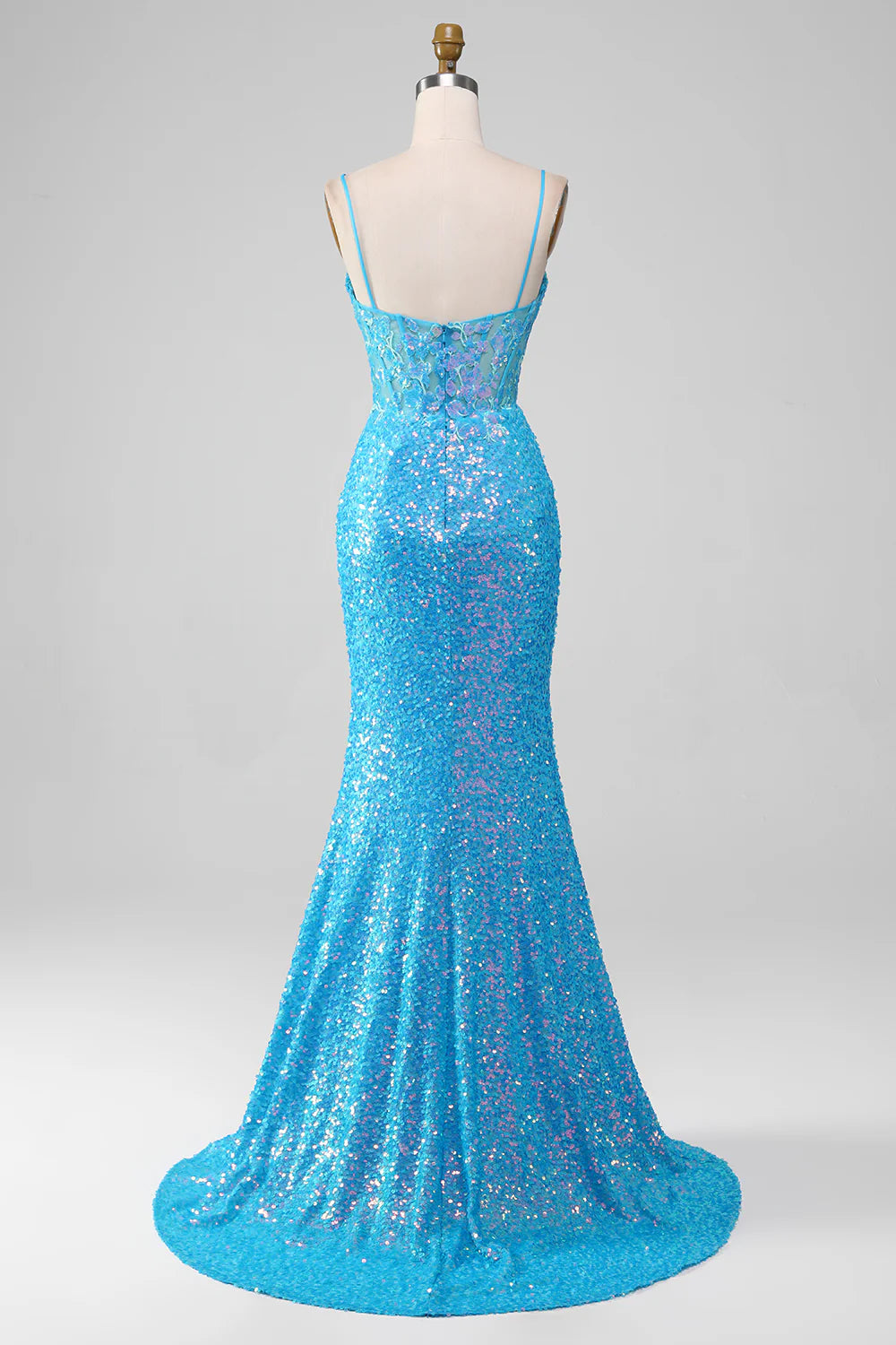 Side profile of blue sparkly prom gown with elegant high slit.