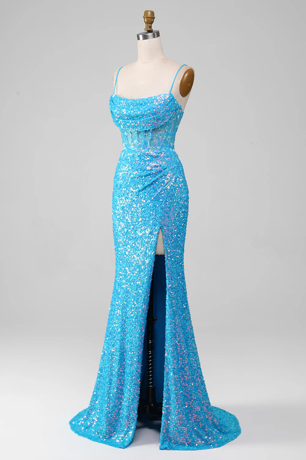 Model wearing a dazzling blue corset prom dress.