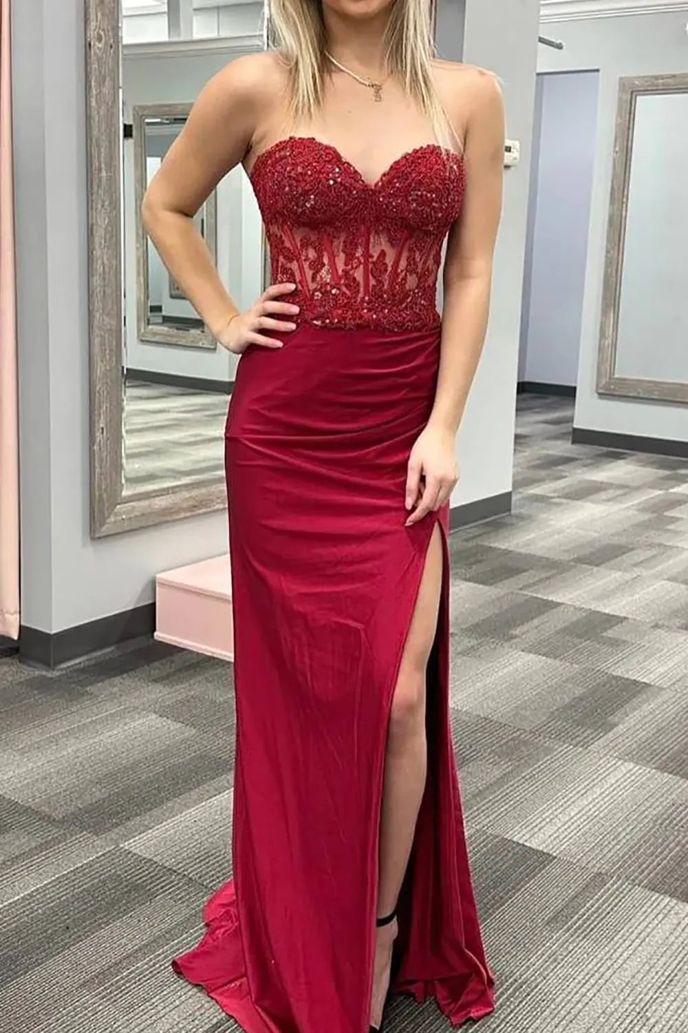 Side profile of the model in the long prom dress, highlighting the slit and silhouette.