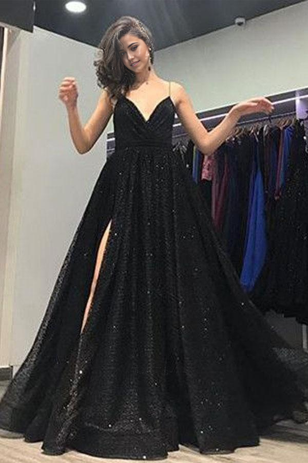 Model wearing a dazzling A-line V-neck black sequin long prom dress with an open back and high split.