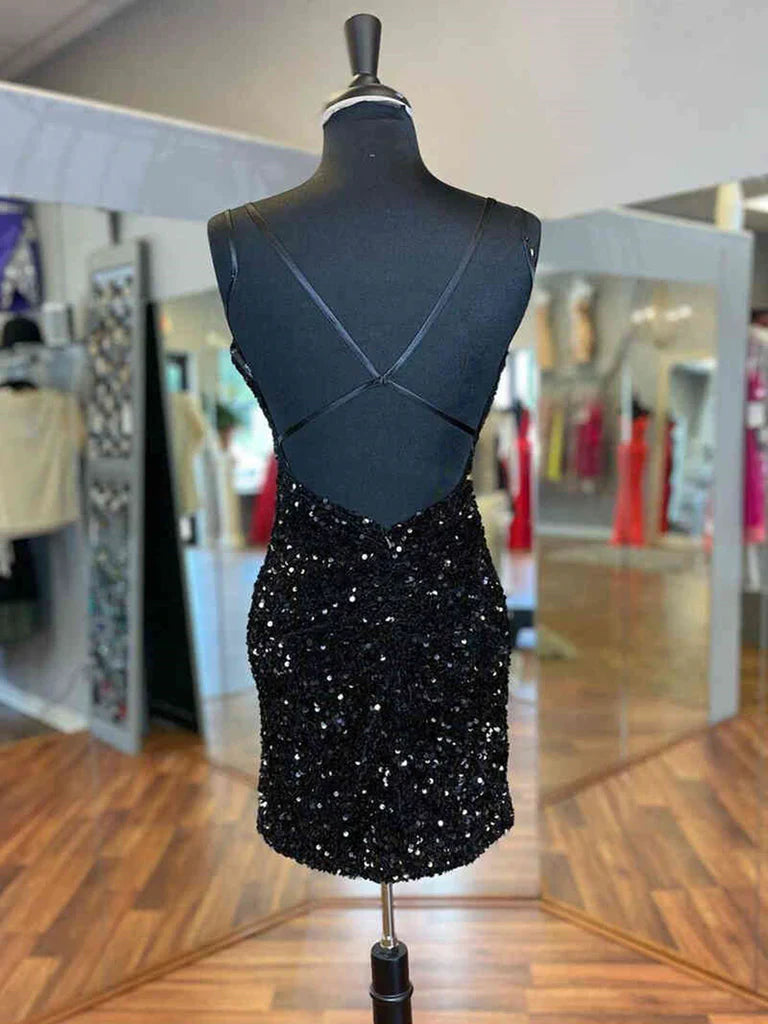 Woman posing in a shimmering short gold sequin backless V-neck party dress.