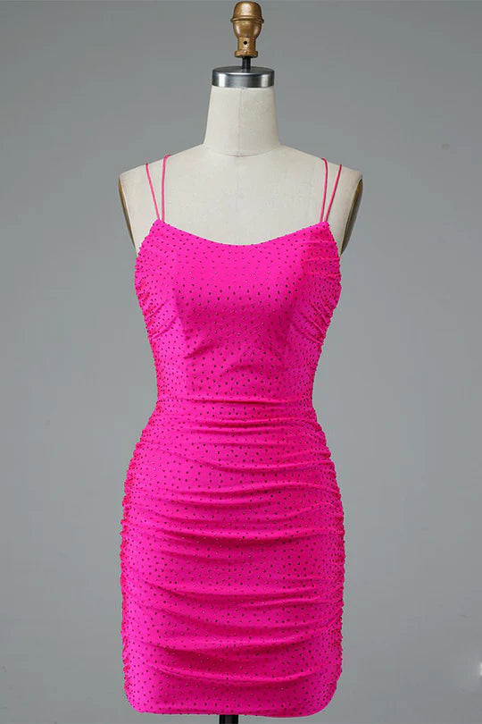 Model in a dazzling silver bodycon mini homecoming dress with double spaghetti straps.