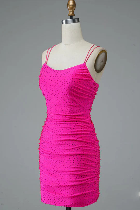 Back view of a model wearing a sparkly bodycon mini dress, highlighting the double spaghetti straps.