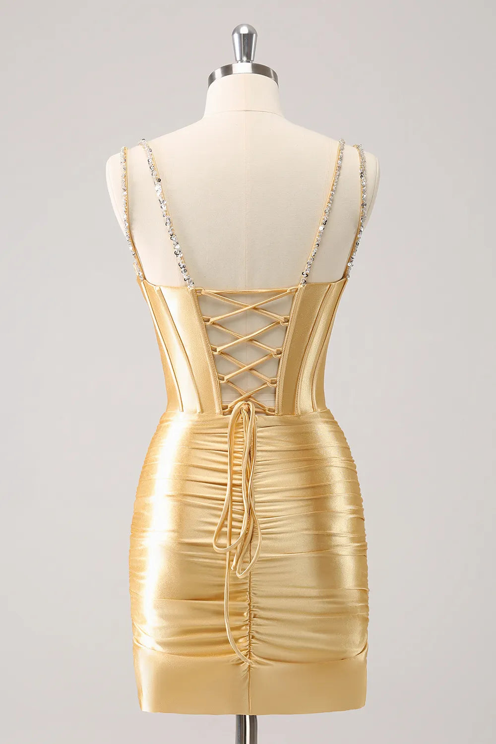 Close-up of the beaded corset bodice and spaghetti straps on the satin homecoming dress.