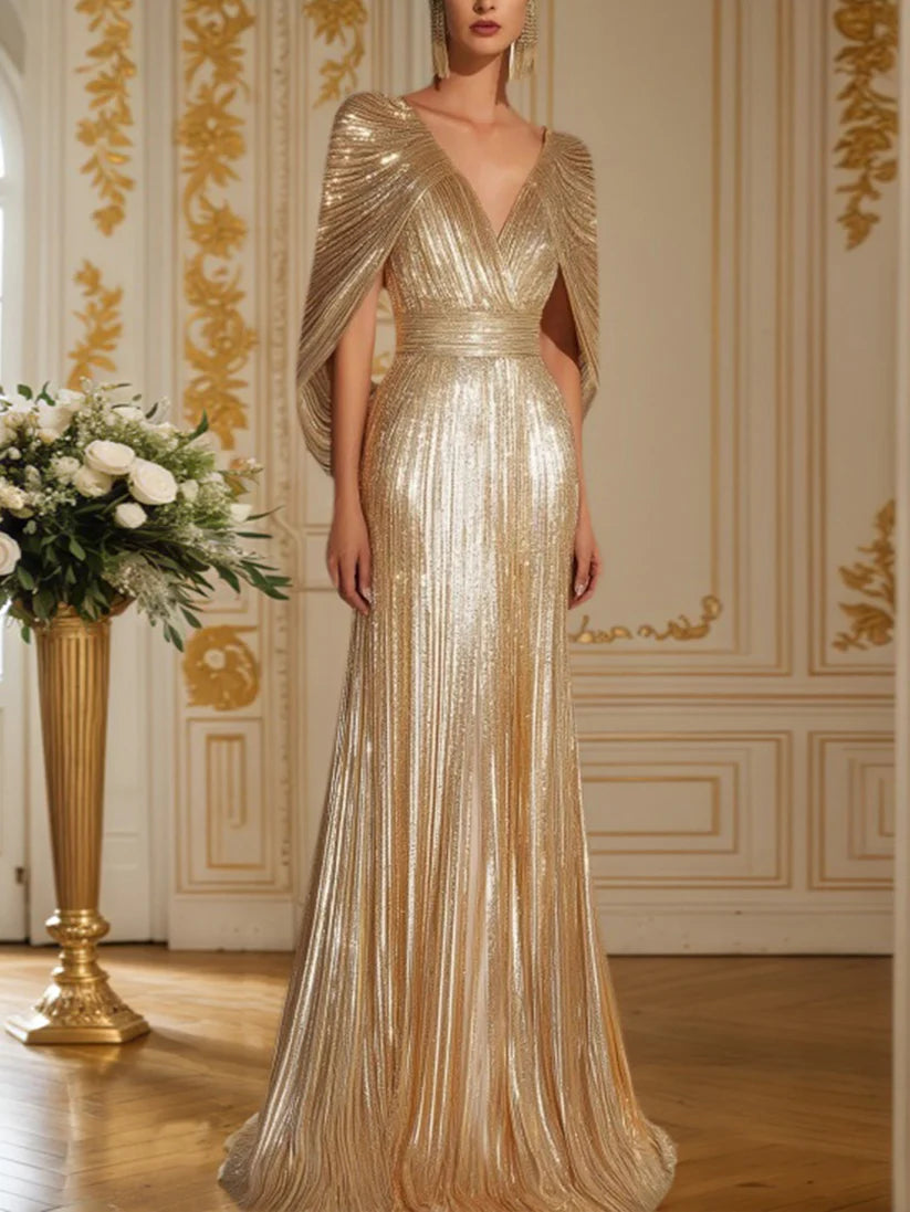 Dazzling gold sequin fringe V-neck cape maxi gown.