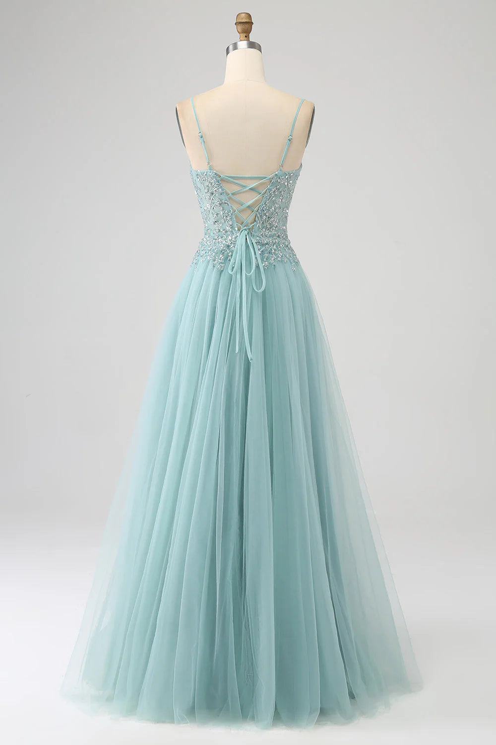Side view of light green sequin A-line gown with elegant slit.