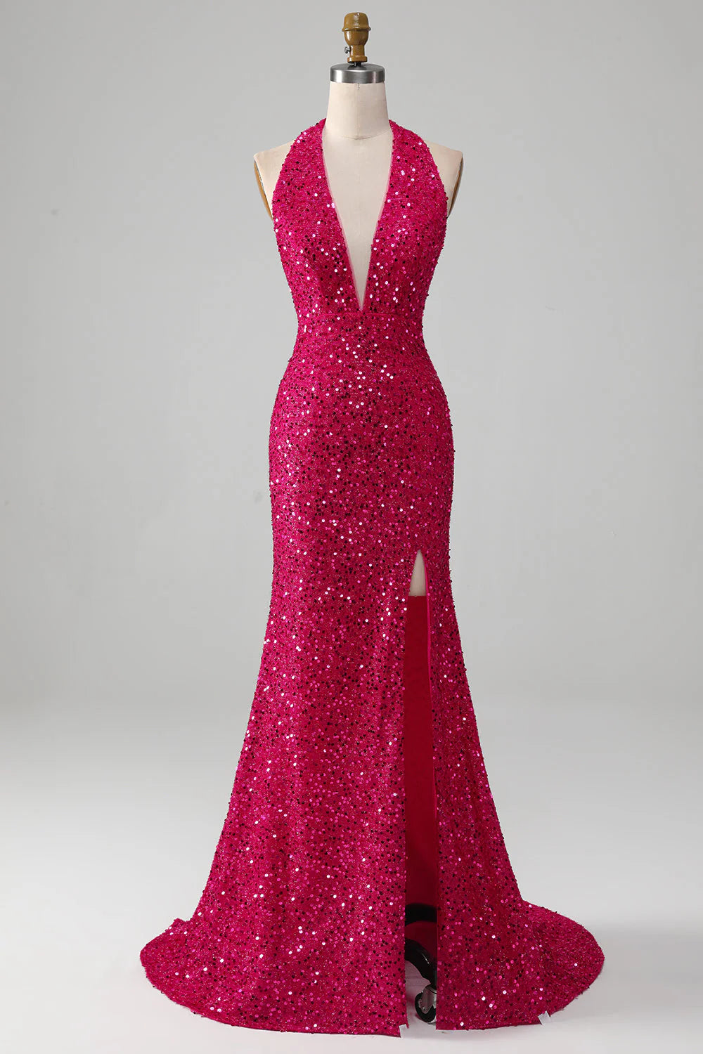 Front view of a fuchsia mermaid halter sequin prom dress with a high slit.