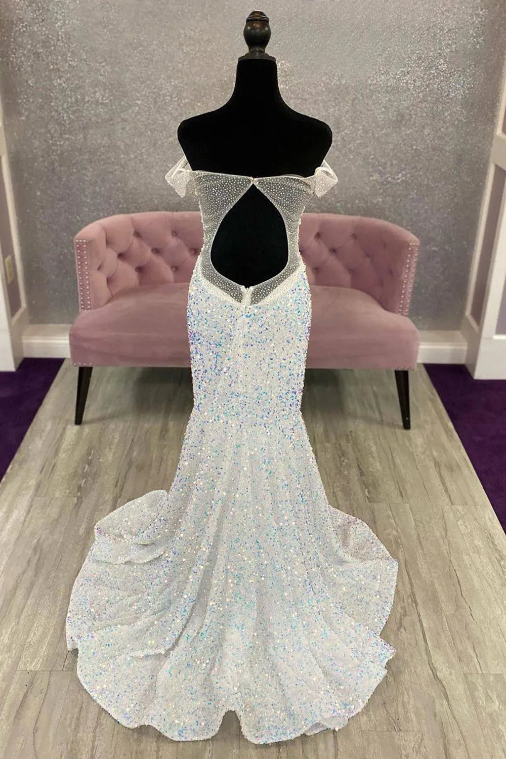 Back view of an elegant off-shoulder sequin mermaid prom dress, showcasing the open back.