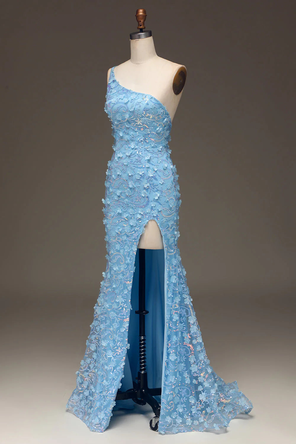 Model posing in a light blue one-shoulder mermaid dress with side slit.
