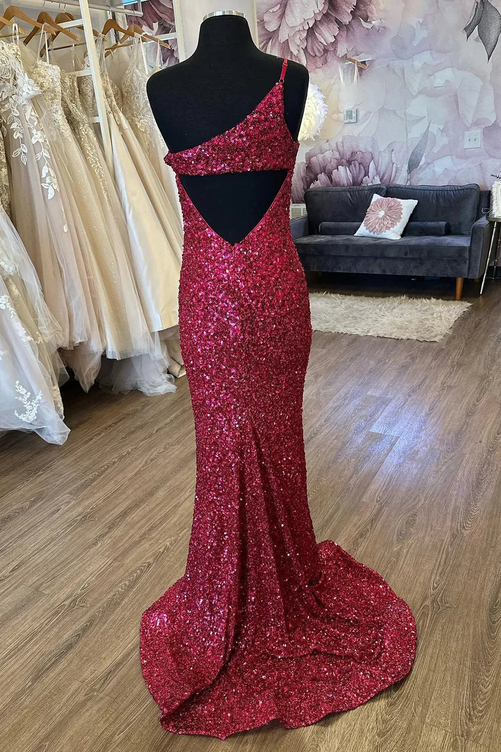 Elegant mermaid one-shoulder sequin dress, showcasing the side profile and flowing silhouette.