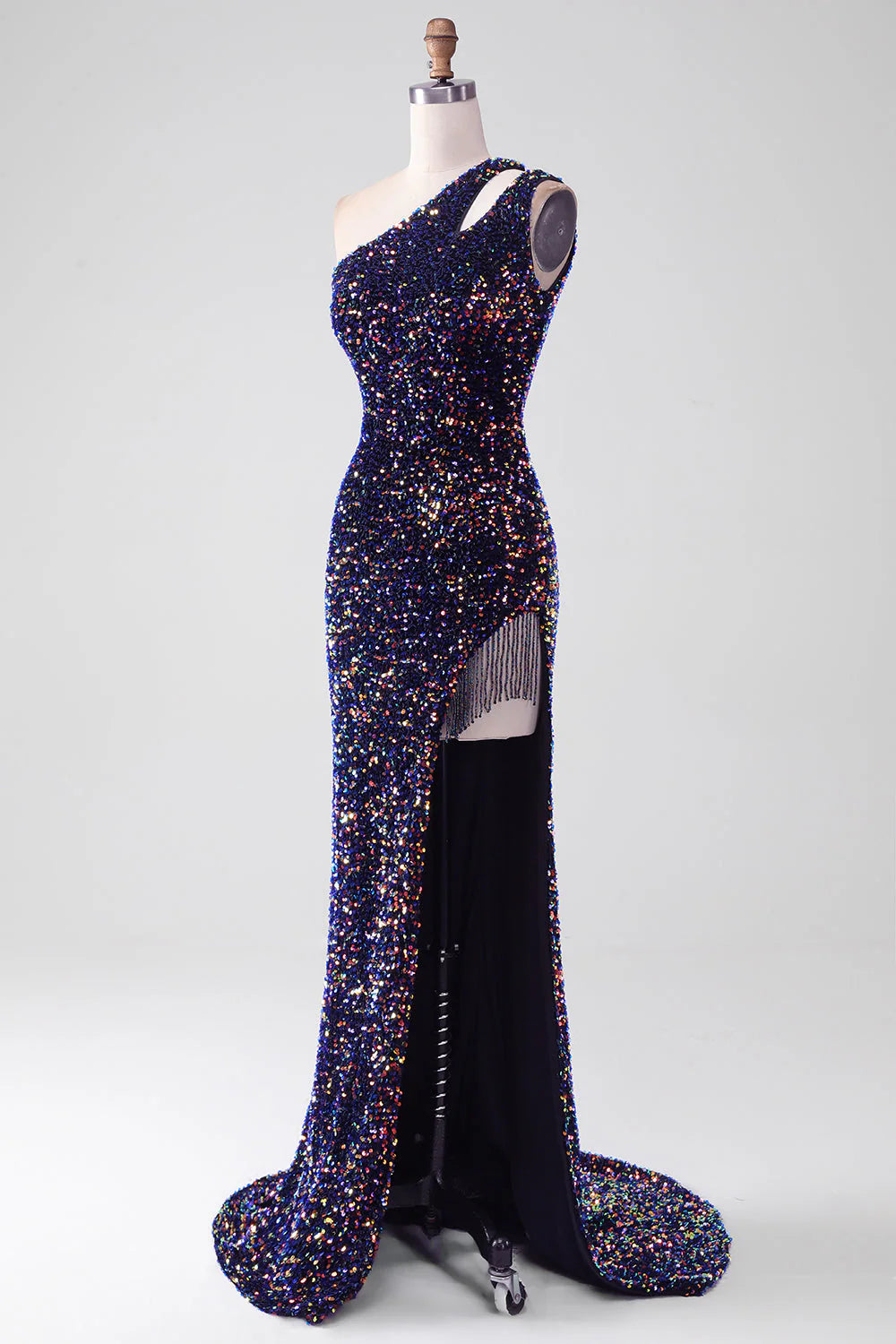 Side view of a woman wearing a black sequin mermaid gown.