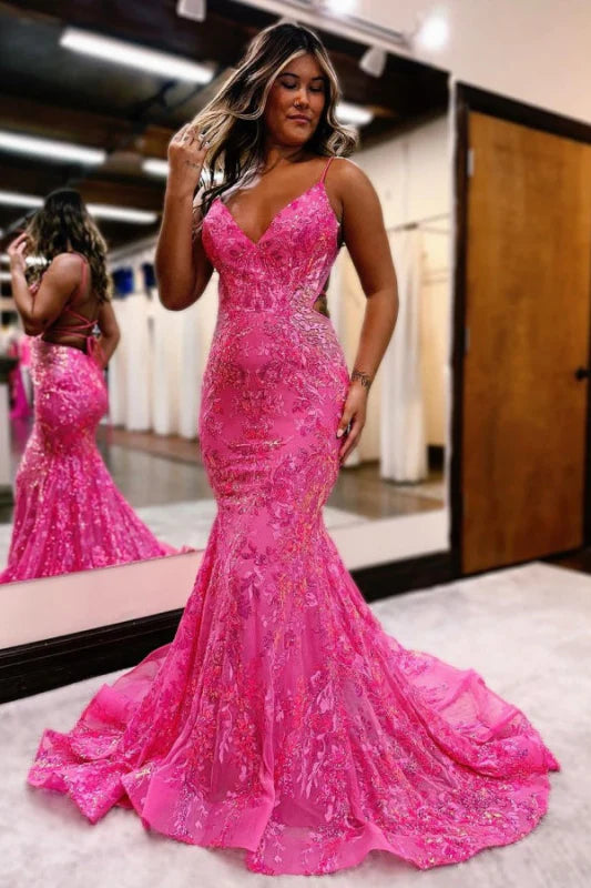 Model wearing a dazzling mermaid sequin prom dress with spaghetti straps and an open back.