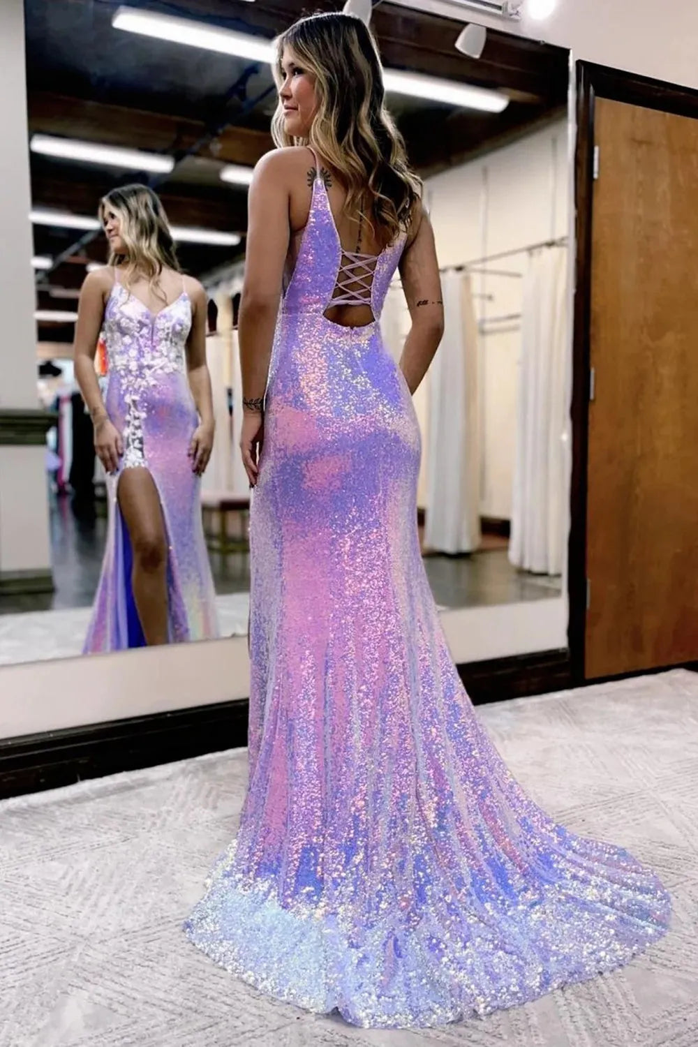 Back view of a shimmering mermaid sequin gown with spaghetti straps.