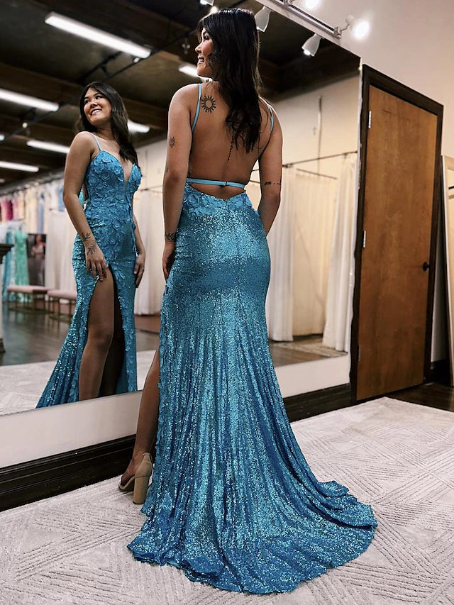 Close-up of the sequin details and appliques on a formal V-neck gown.